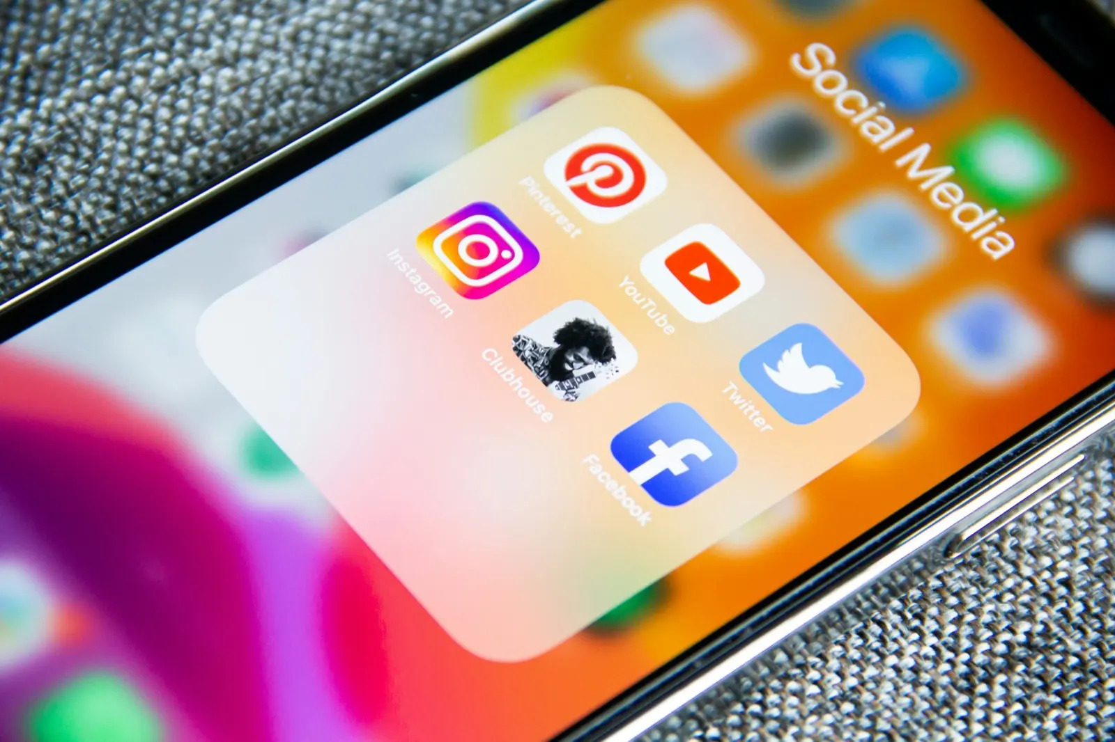 A smartphone screen with a Social Media folder holding the Facebook, Instagram, YouTube and Twitter apps