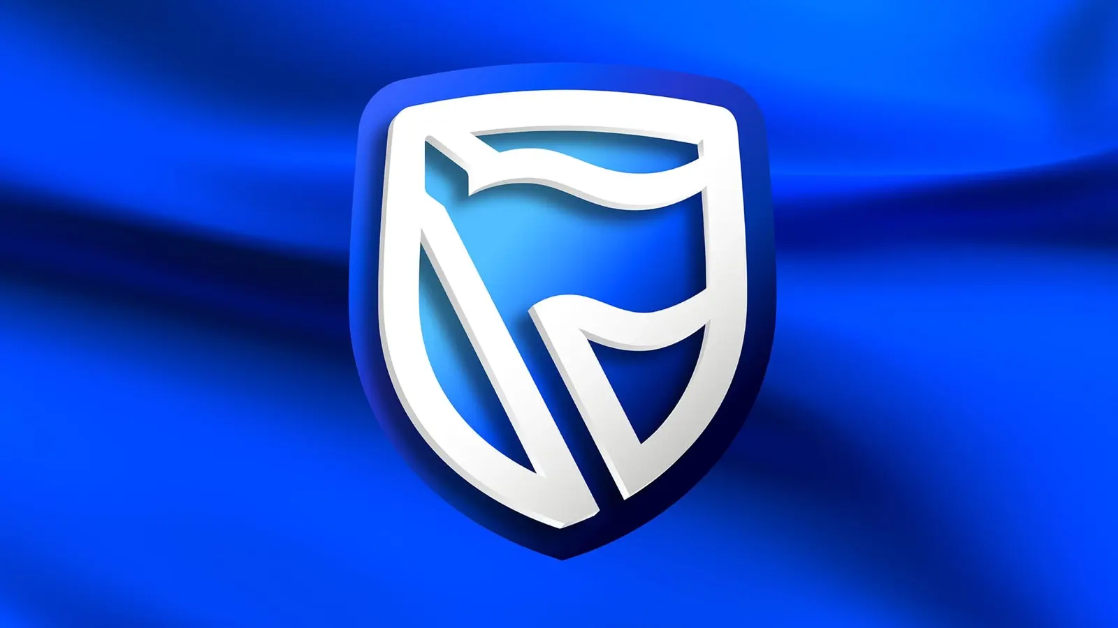 The white Standard Bank and Stanbic shield logo on a blue background